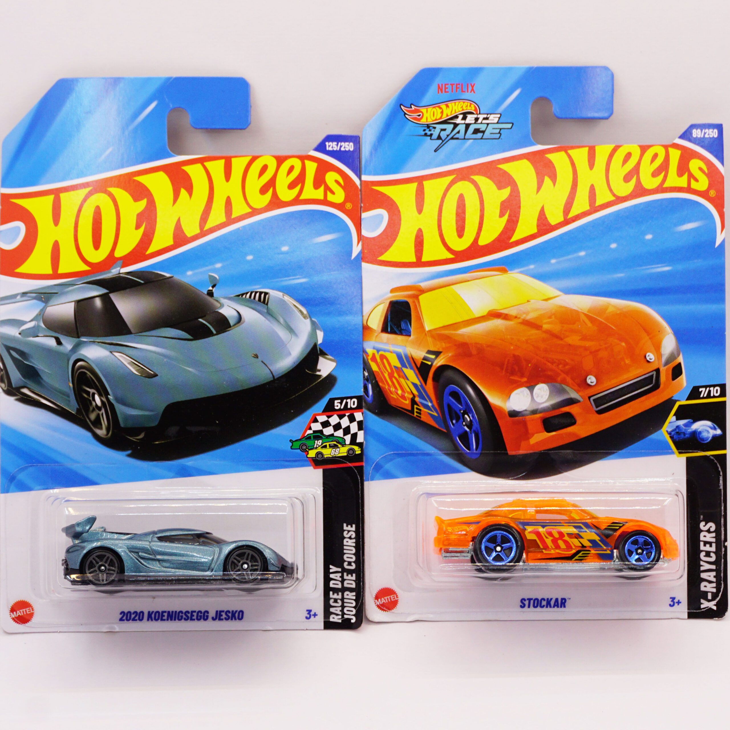 Hot Wheels Mainlines die-cast cars, featuring grey 2020 Koenigsegg Jesko and orange Stockar fantasy race car, 2025 releases at RACEiN PARC