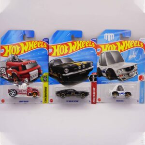 Hot Wheels Mainlines die-cast cars, featuring black '67 Shelby GT500 and red Crate Racer fantasy, along with white Mazda RY-3, 2025 releases at RACEiN PARC