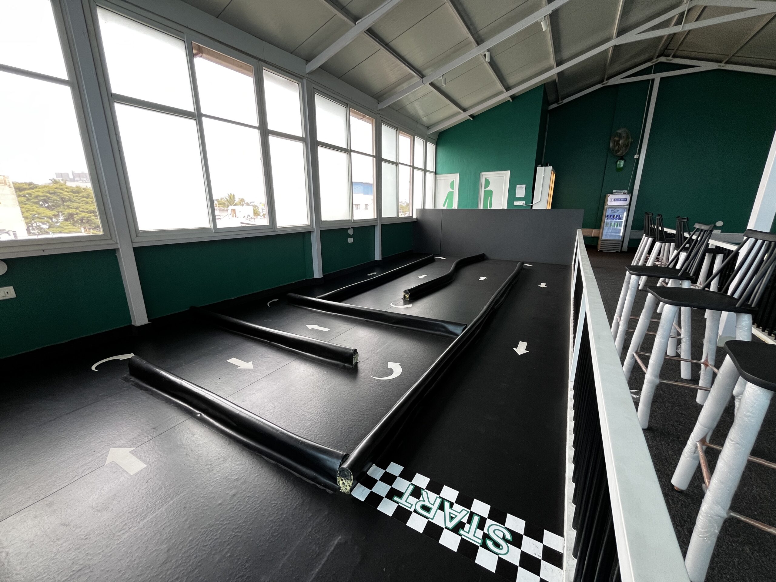 Beginner learning RC racing on an indoor track at RACEiN PARC Bengaluru